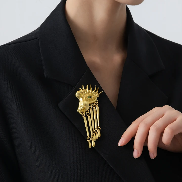 Eye brooch with drops shown in worn / black tailoring